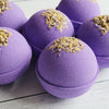 group of large lavender bath bomb with chamomile flowers on top