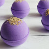 lavender bath bomb with chamomile flowers on top
