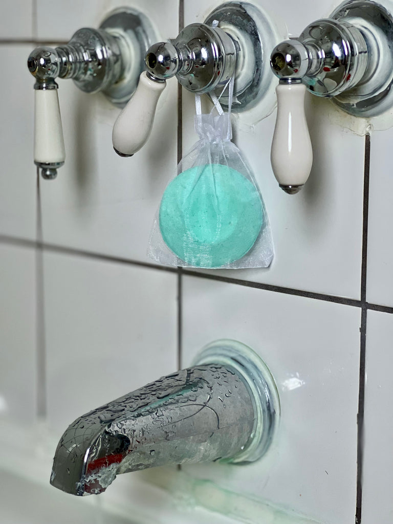 green eucalyptus mint steamer in bag on bath faucet knobs